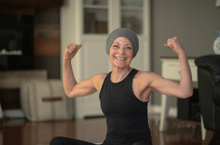 woman cancer patient flexing muscles